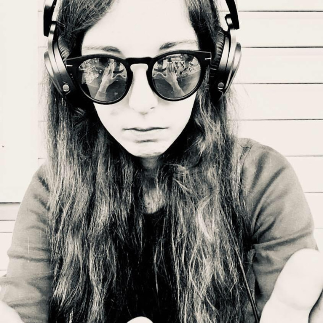 Black and white image of Morgazmk in sunglasses and headphones