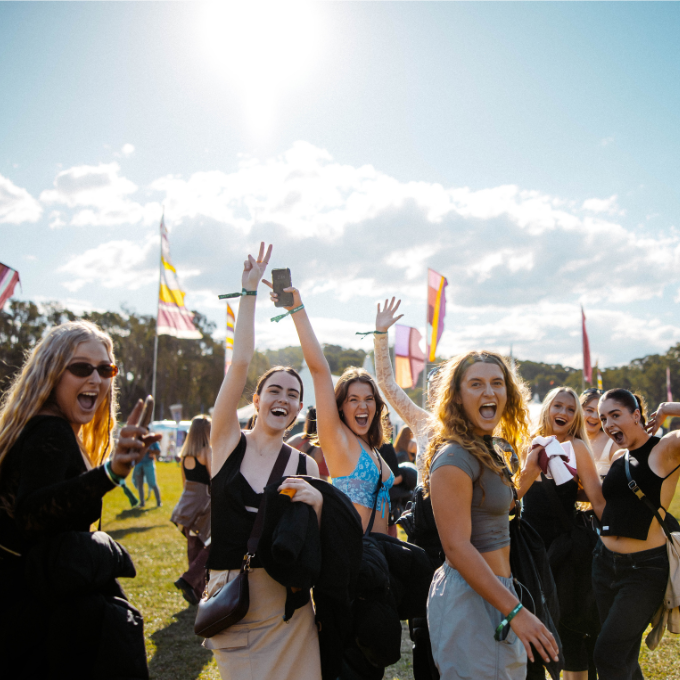 A group of friends turn to pose for the camera at Splendour